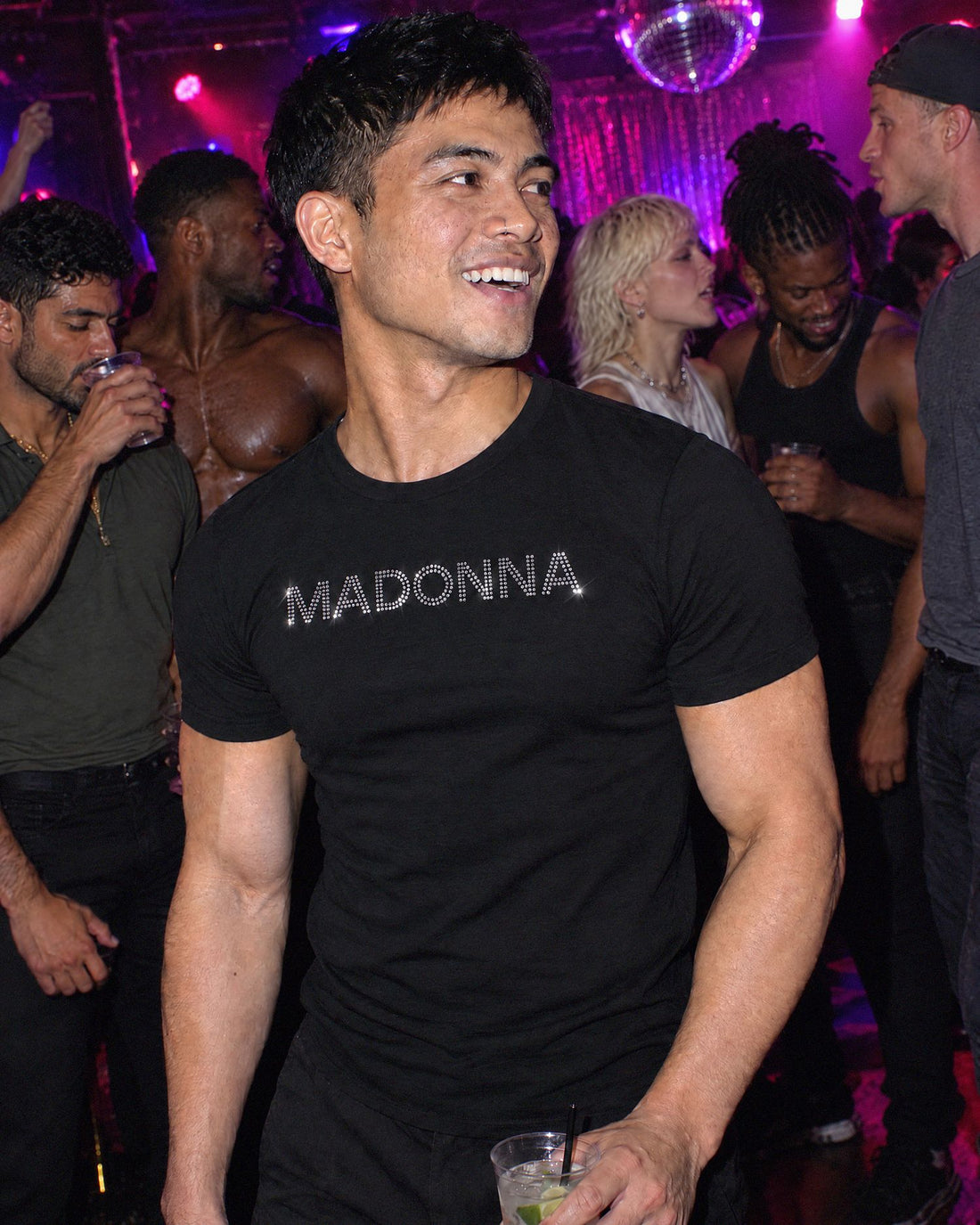 A man at a party wearing the Madonna shirt