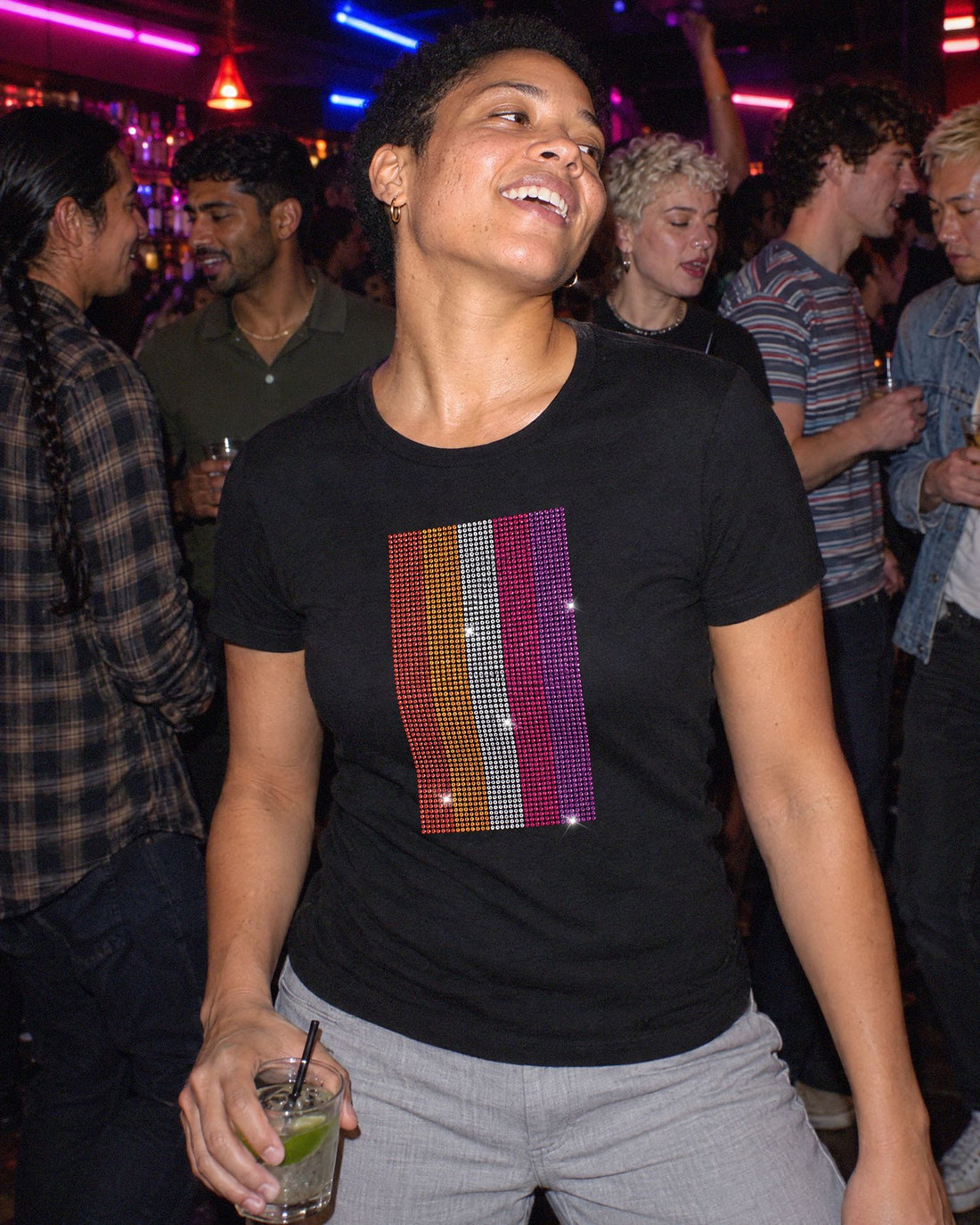A woman at a party wearing the Lesbian Pride fitted tee