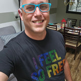 Man wearing black "I Feel So Free" rainbow rhinestone Pride t-shirt, taking a selfie at home by Rico Starr

