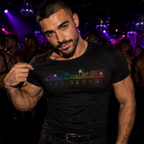 A muscular man in a gay nightclub setting wearing a rhinestone rainbow skyline of Las Vegas by Rico Starr
