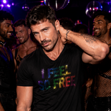 Male model wearing a fitted black t-shirt with rainbow rhinestone “I Feel So Free” lettering inspired by LGBTQ Pride and disco nightlife fashion by Rico Starr