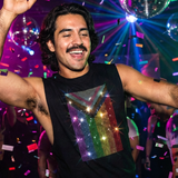 Black sleeveless shredder with rhinestone Progress Pride flag design, gay men’s clubwear by Rico Starr
