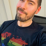 Man wearing a black t-shirt featuring a rhinestone rainbow world map graphic. LGBTQ+ Pride apparel celebrating queer visibility, equality, and community with vibrant rainbow colors and sparkling rhinestone details by Rico Starr