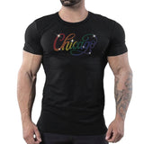 Male model wearing a fitted black t-shirt featuring a rainbow rhinestone “Chicago” script design inspired by LGBTQ Pride, disco fashion, and nightlife culture by Rico Starr