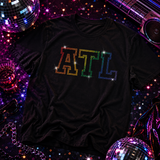 A black short-sleeve T-shirt featuring the letters 'ATL' outlined in rhinestones in rainbow colors by Rico Starr