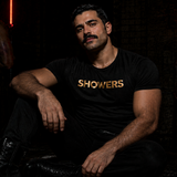 Black t-shirt with gold “Showers” slogan text, gay men’s statement clubwear fetishwear by Rico Starr