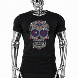Black t-shirt with colorful rhinestone sugar skull graphic featuring floral eye and nose designs, Day of the Dead style by Rico Starr
